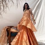 Classic chanderi sharara and sleeveless embroidered kurti in apricot colour. Styled with heavy embroidered organza dupatta