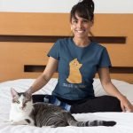 portrait-of-a-happy-cat-owner-wearing-a-t-shirt-mockup-on-bed-a18790